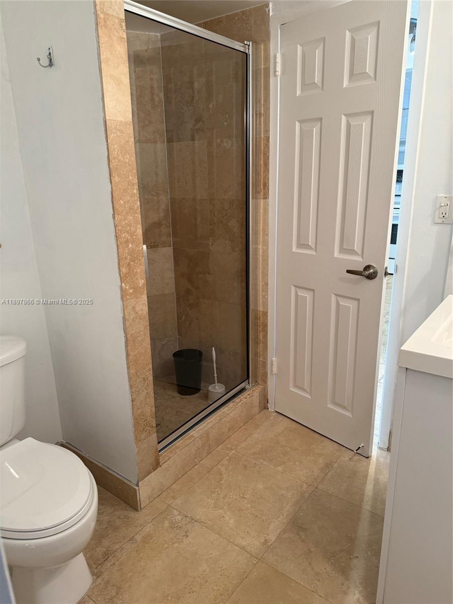 5701 Collins Avenue, Unit 1207 Miami Beach, FL 33140 - Photo 16 of 44 a bathroom with a toilet and a shower