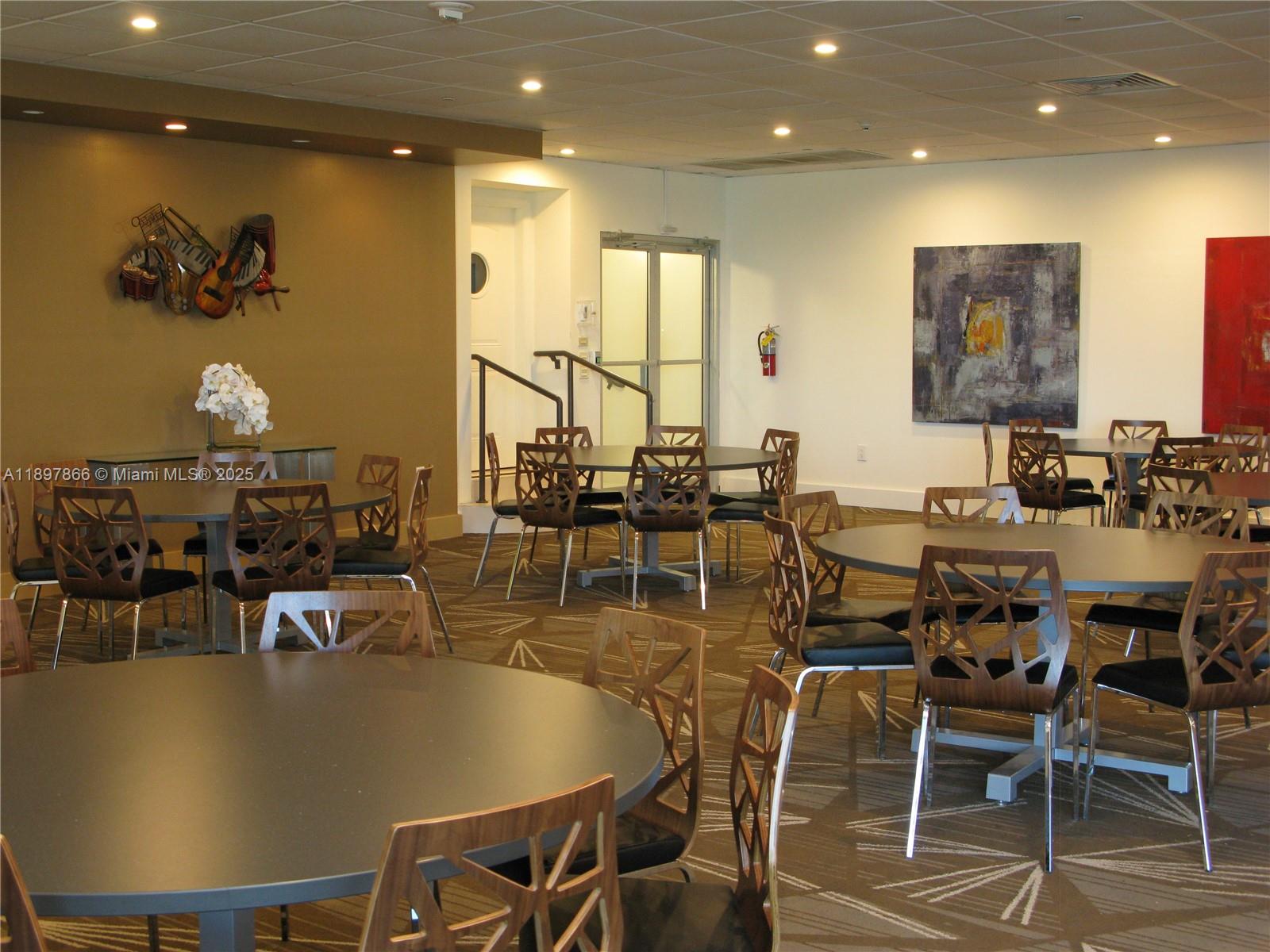 5701 Collins Avenue, Unit 1207 Miami Beach, FL 33140 - Photo 23 of 44 a view of a dining room with furniture