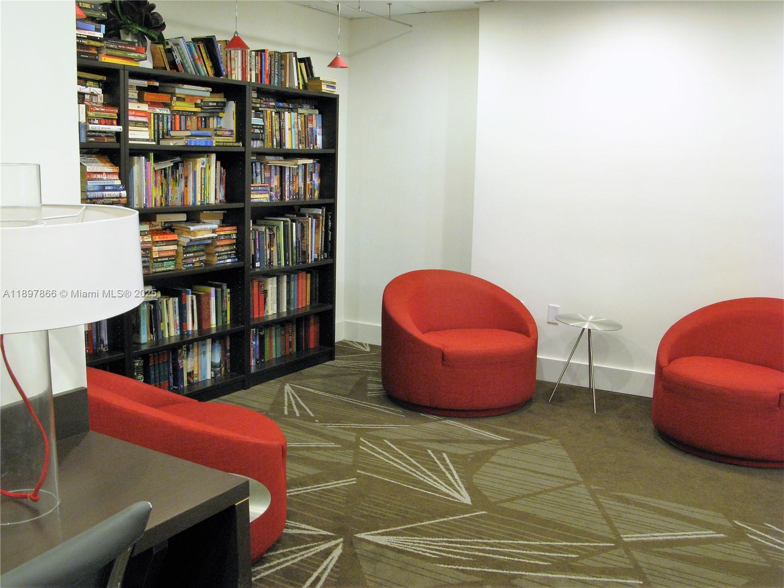 5701 Collins Avenue, Unit 1207 Miami Beach, FL 33140 - Photo 25 of 44 a room with furniture and book shelf