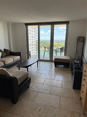 a bedroom with furniture and large windows