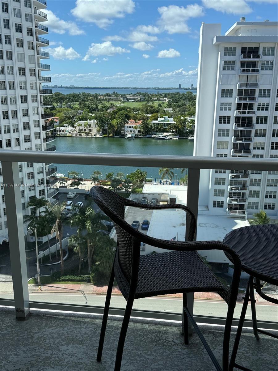 5701 Collins Avenue, Unit 1207 Miami Beach, FL 33140 - Photo 10 of 44 a view of a chairs and table in the terrace