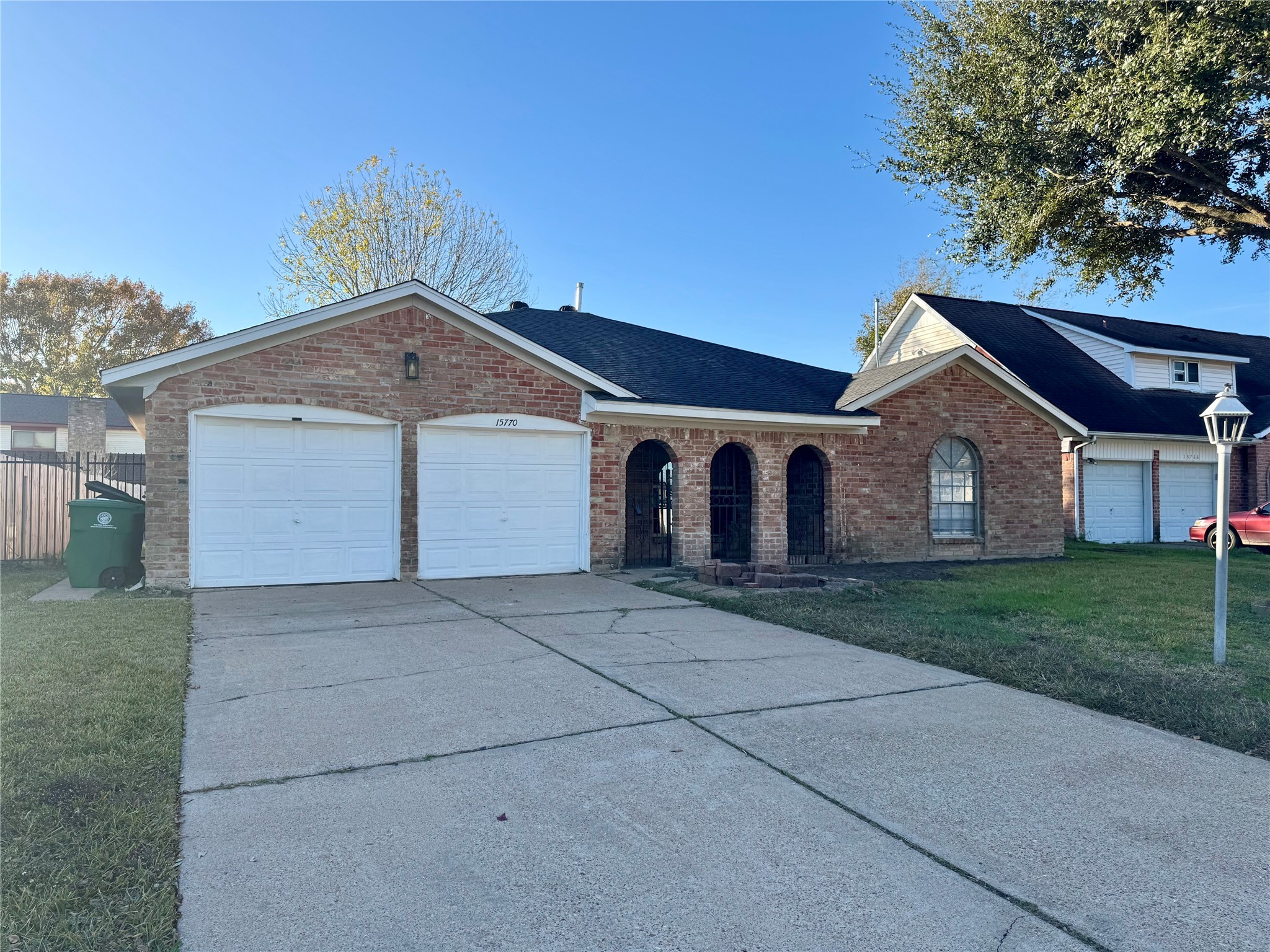 15770 Chimney Rock Road Houston, TX 77489 - Photo 1 of 42 a front view of a house with a yard and garage
