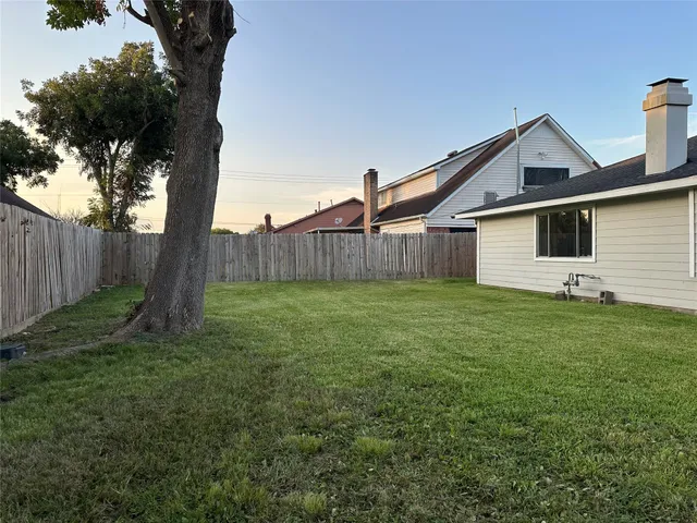 a front view of house with backyard and green space