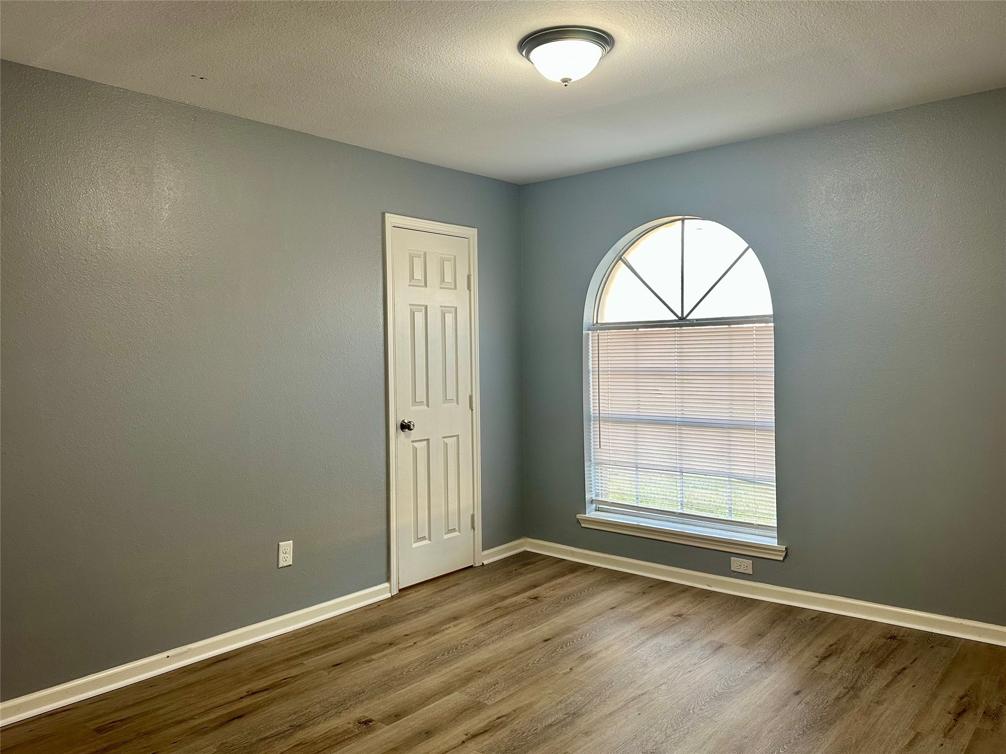15770 Chimney Rock Road Houston, TX 77489 - Photo 24 of 42 an empty room with wooden floor closet and windows