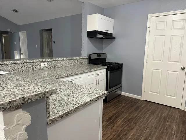 a kitchen with a sink and a stove
