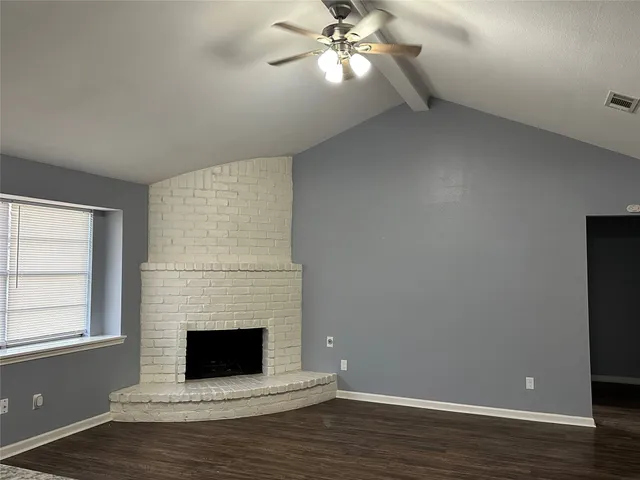 a view of a livingroom with a fireplace and window