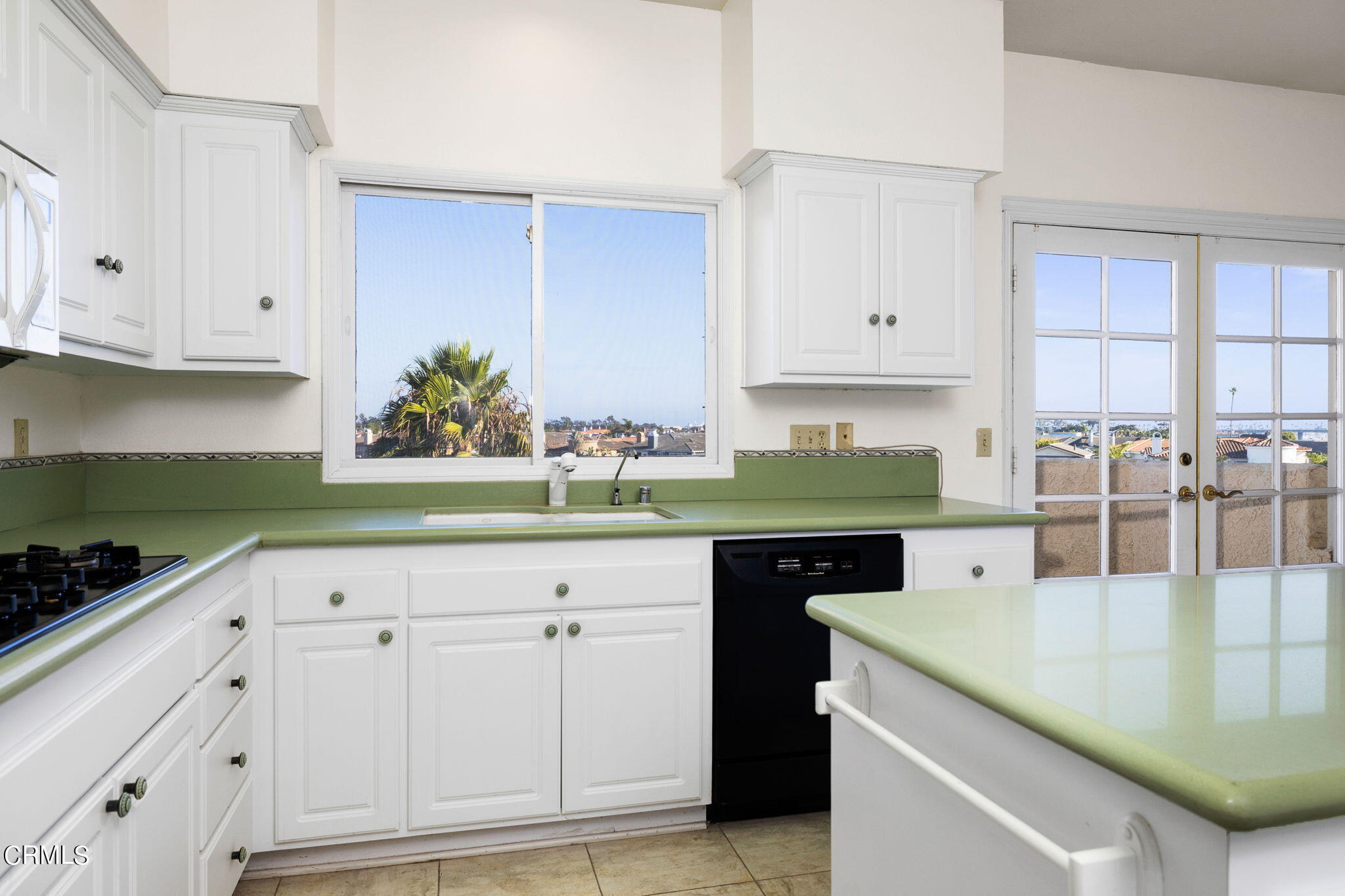 4212 Harbour Island Lane Oxnard, CA 93035 - Photo 25 of 48 a kitchen with granite countertop a sink a stove and cabinets
