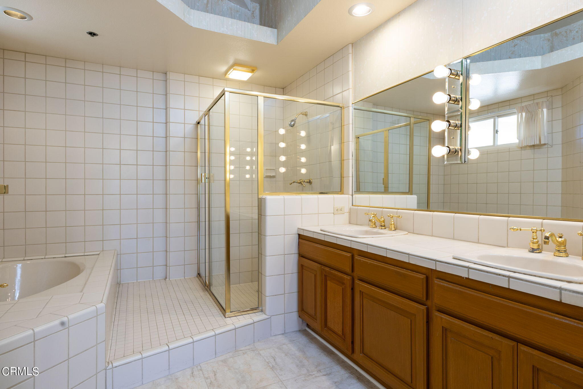 4212 Harbour Island Lane Oxnard, CA 93035 - Photo 30 of 48 a bathroom with a double vanity sink a toilet a mirror and shower