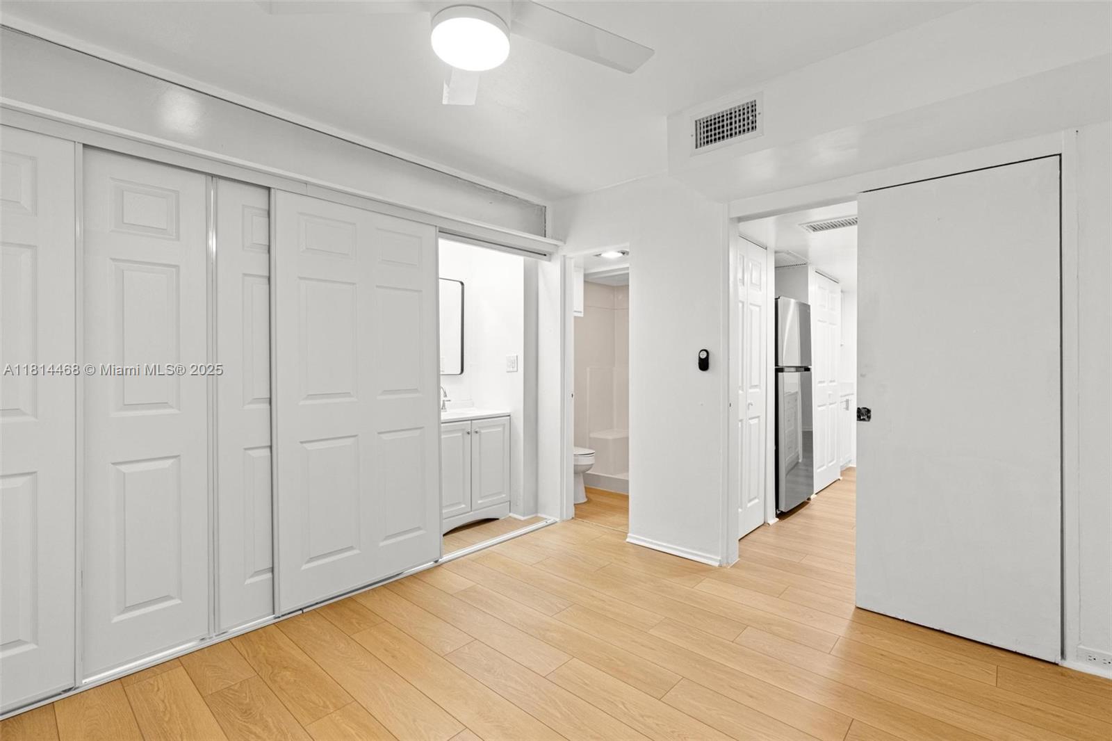 15007 Coconut Court Miami Lakes, FL 33014 - Photo 16 of 27 a view of an empty room with wooden floor