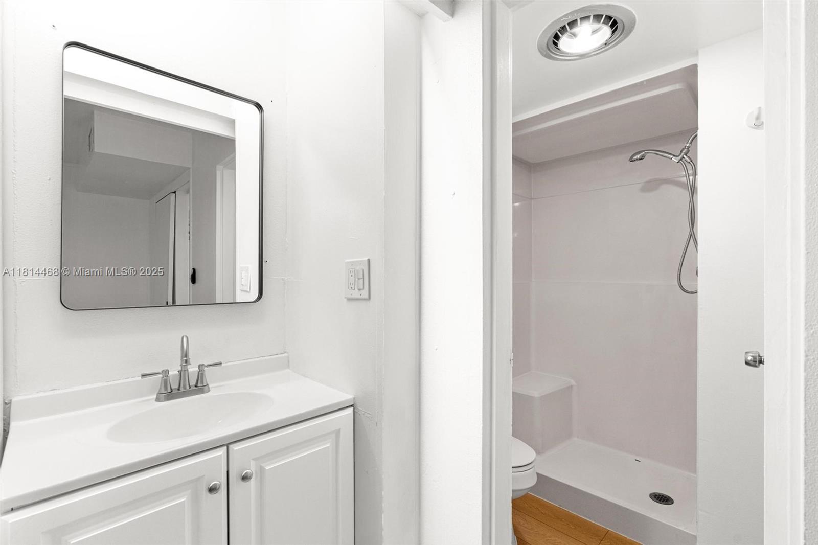 15007 Coconut Court Miami Lakes, FL 33014 - Photo 17 of 27 a bathroom with a shower sink and mirror