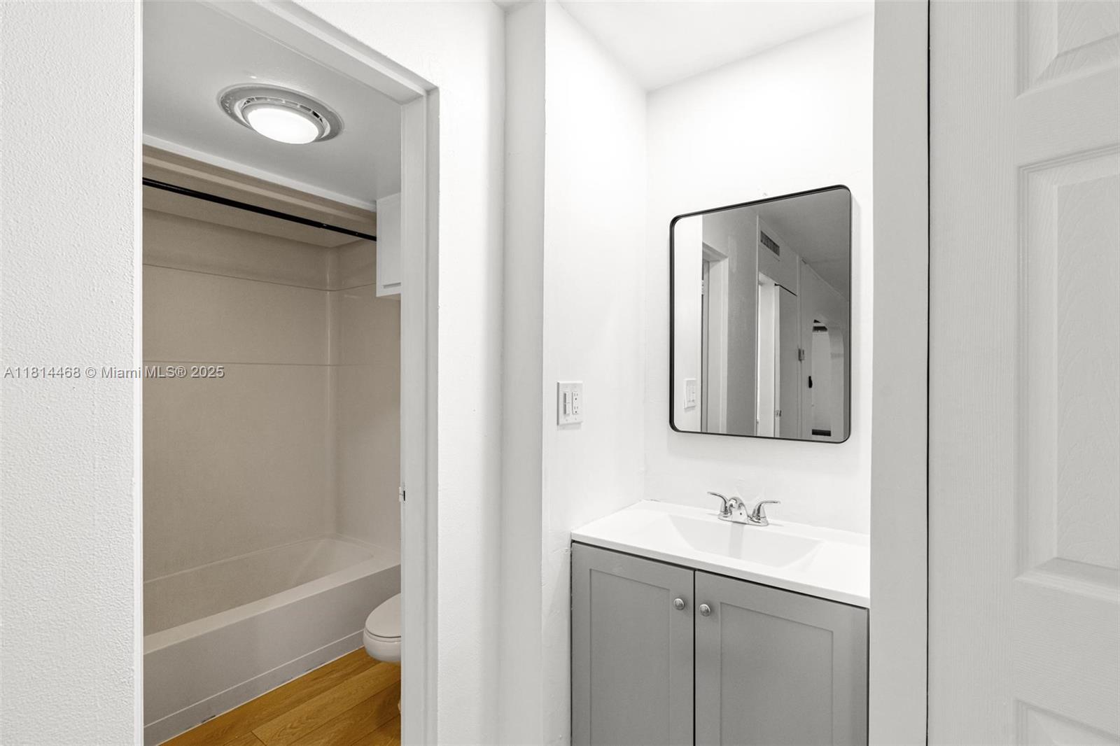 15007 Coconut Court Miami Lakes, FL 33014 - Photo 20 of 27 a bathroom with a shower a sink and a mirror