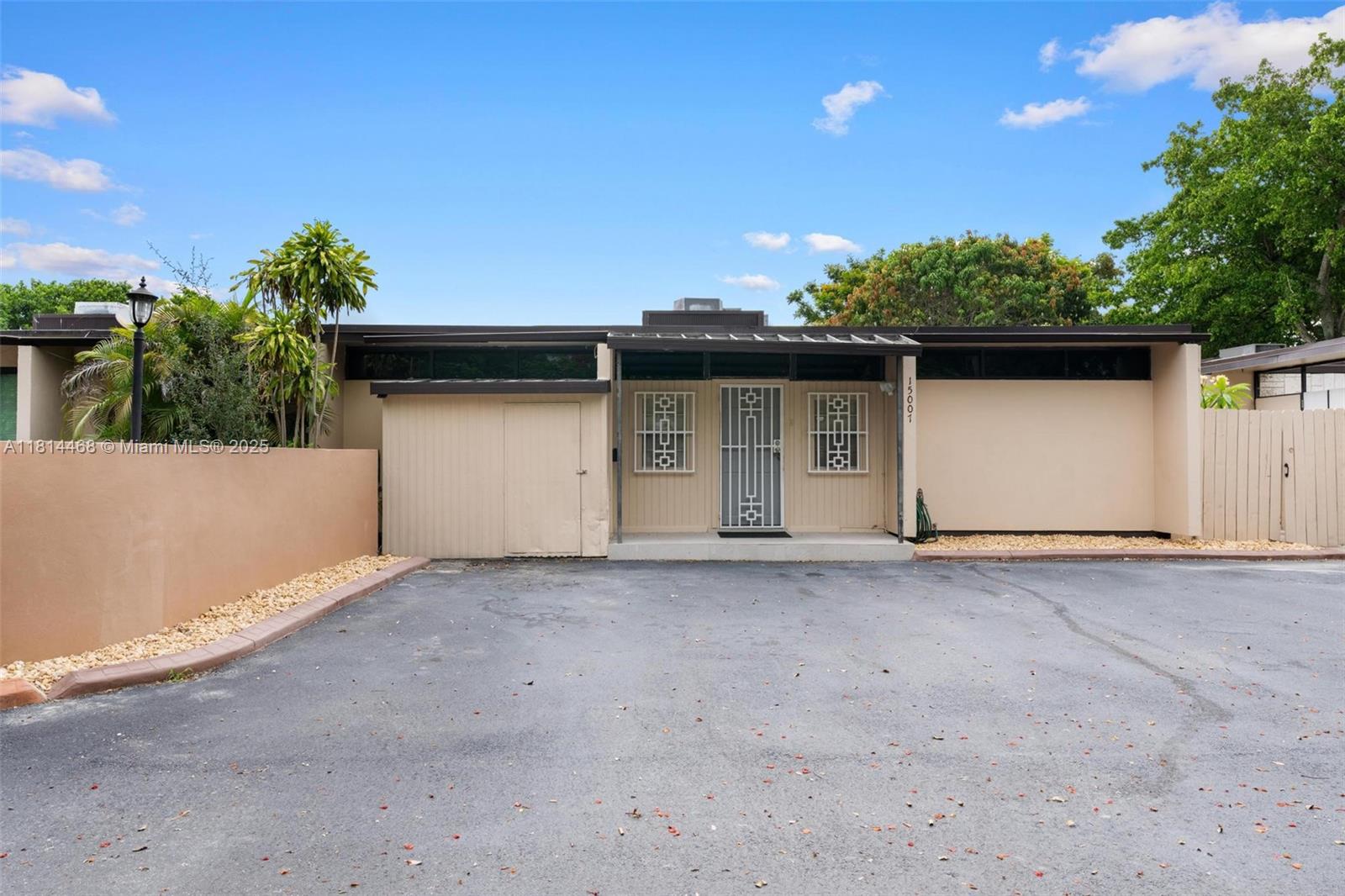 15007 Coconut Court Miami Lakes, FL 33014 - Photo 3 of 27 a house with trees in the background