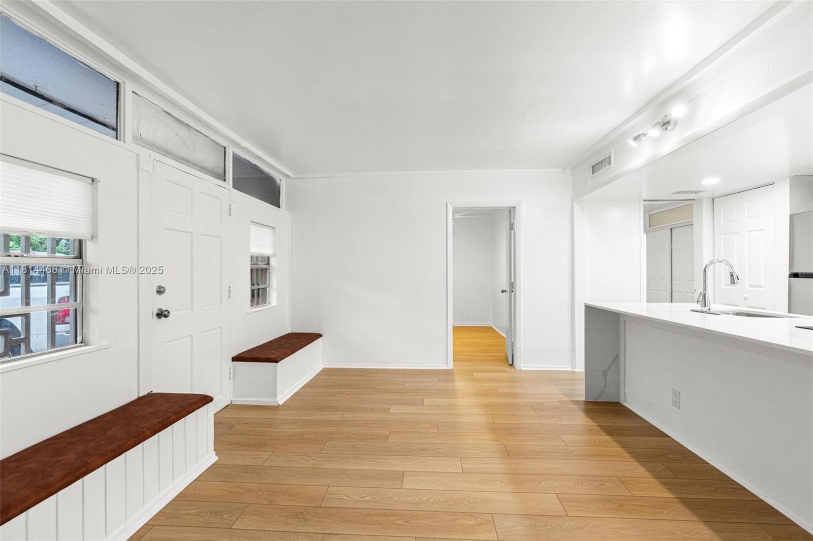 15007 Coconut Court Miami Lakes, FL 33014 - Photo 8 of 27 a view of an empty room with window and wooden floor