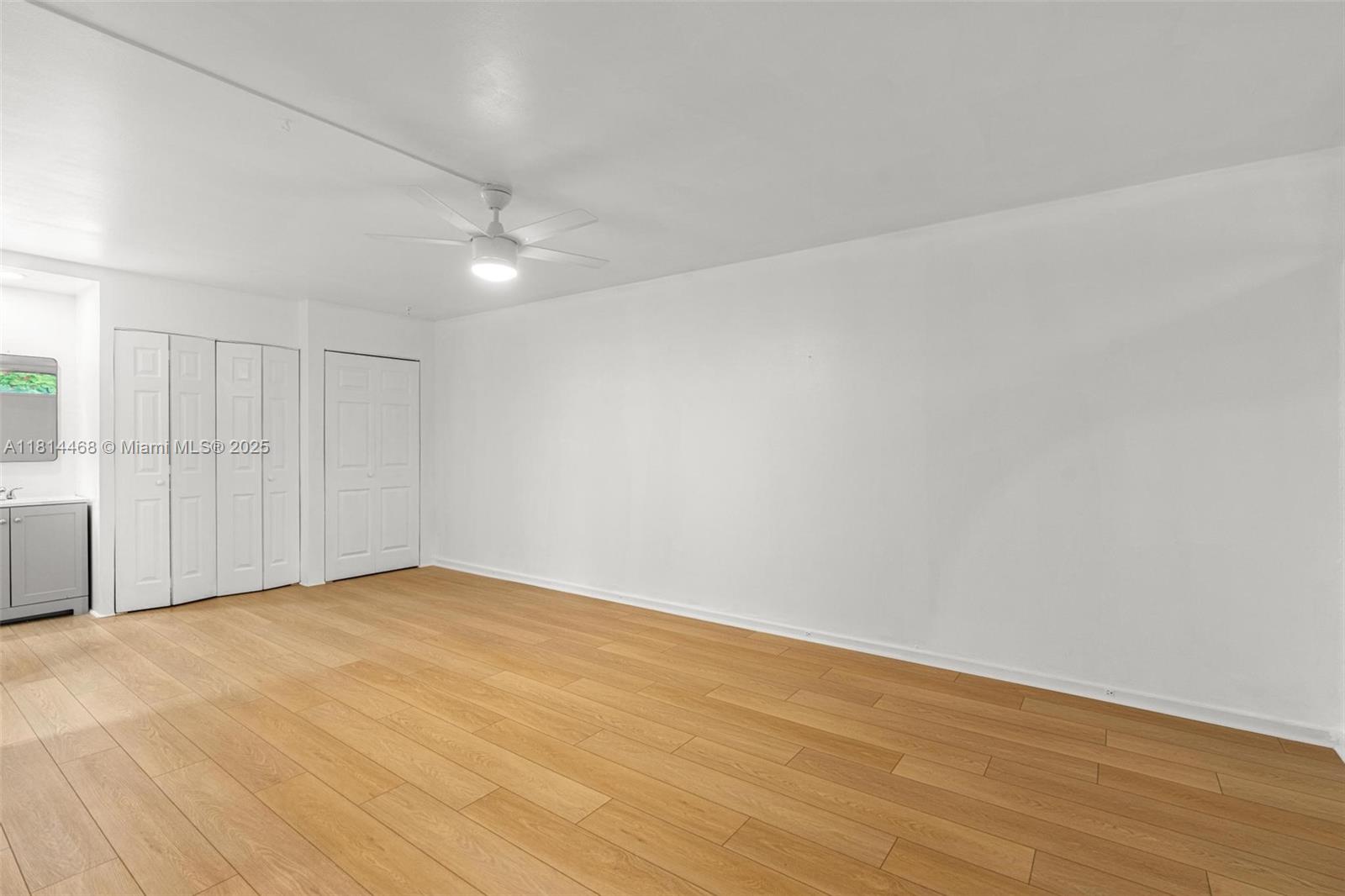 15007 Coconut Court Miami Lakes, FL 33014 - Photo 9 of 27 a view of an empty room with wooden floor