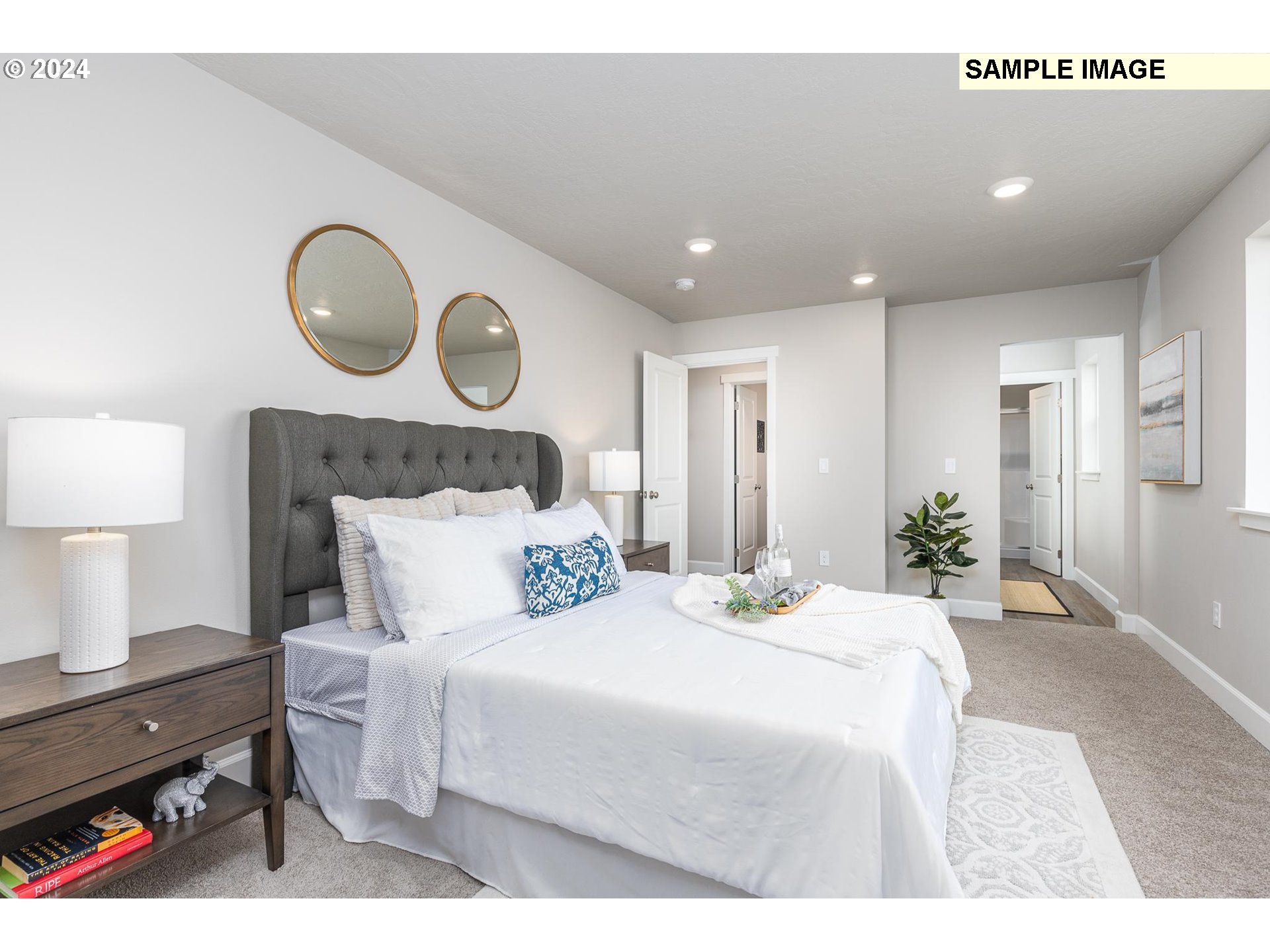 1734 Northeast 9th Street Hermiston, OR 97838 - Photo 18 of 31 a bedroom with a bed a mirror and a lamp on dresser