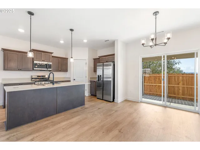 a view of a backyard with wooden fence