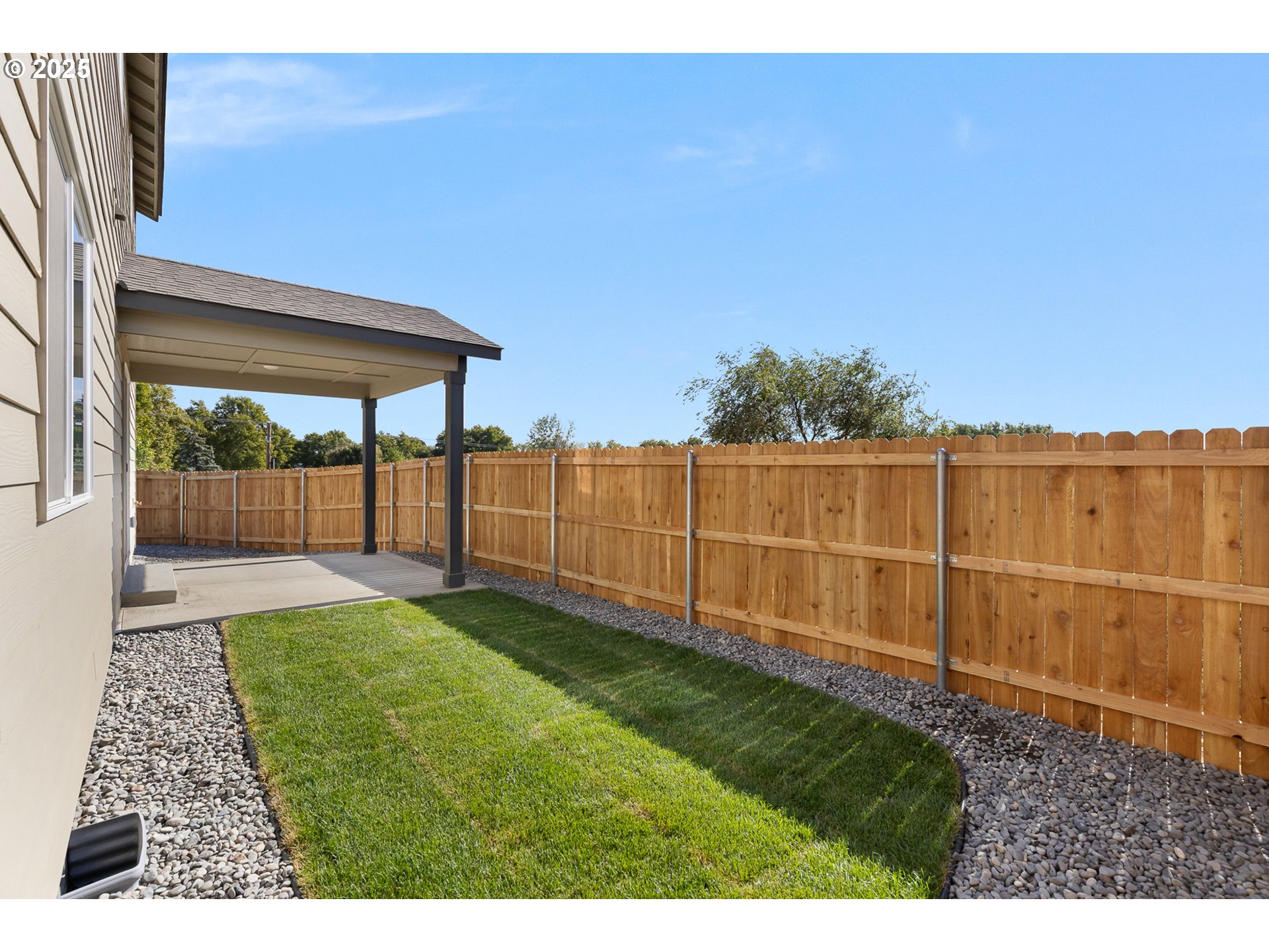 1734 Northeast 9th Street Hermiston, OR 97838 - Photo 27 of 31 a view of a backyard with wooden fence
