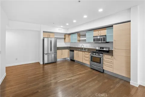 a kitchen with stainless steel appliances a refrigerator stove and sink