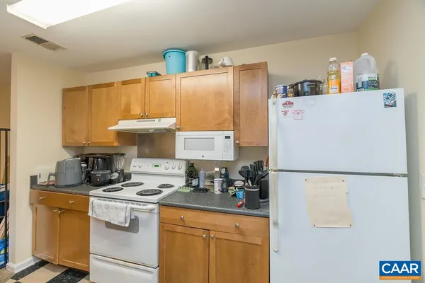 a view of a workspace with furniture and wooden floor