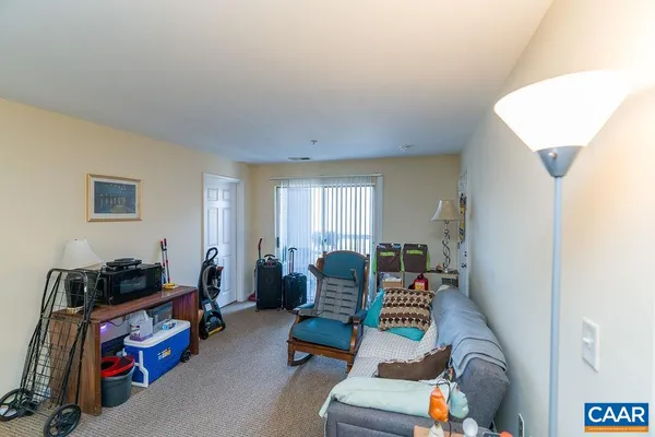 a living room with lots of furniture and clutter
