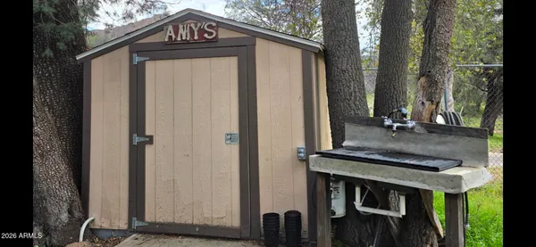 a view of a house with a door and wooden fence