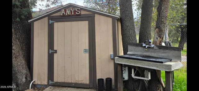 a view of a house with a door and wooden fence