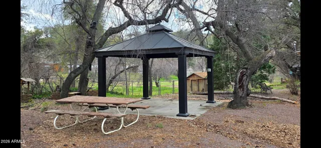 a backyard of a house with table and chairs