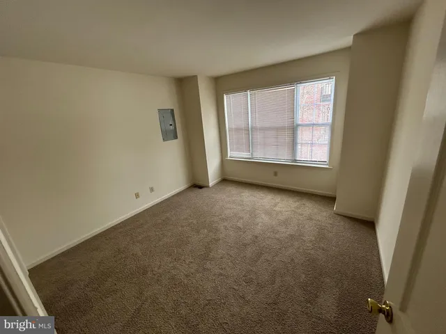 an empty room with a empty space and windows