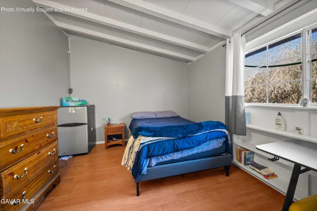 a bedroom with a bed window and couch