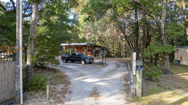 a view of a wooden house with a tree
