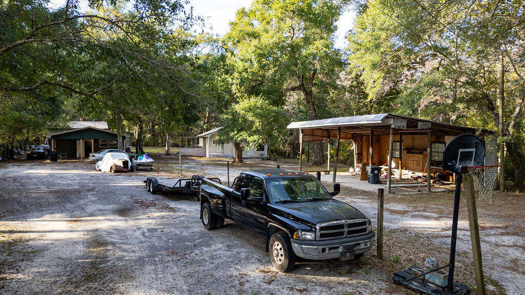 78 April Court Freeport, FL 32439 - Photo 14 of 18 a backyard of a house with barbeque oven table and chairs