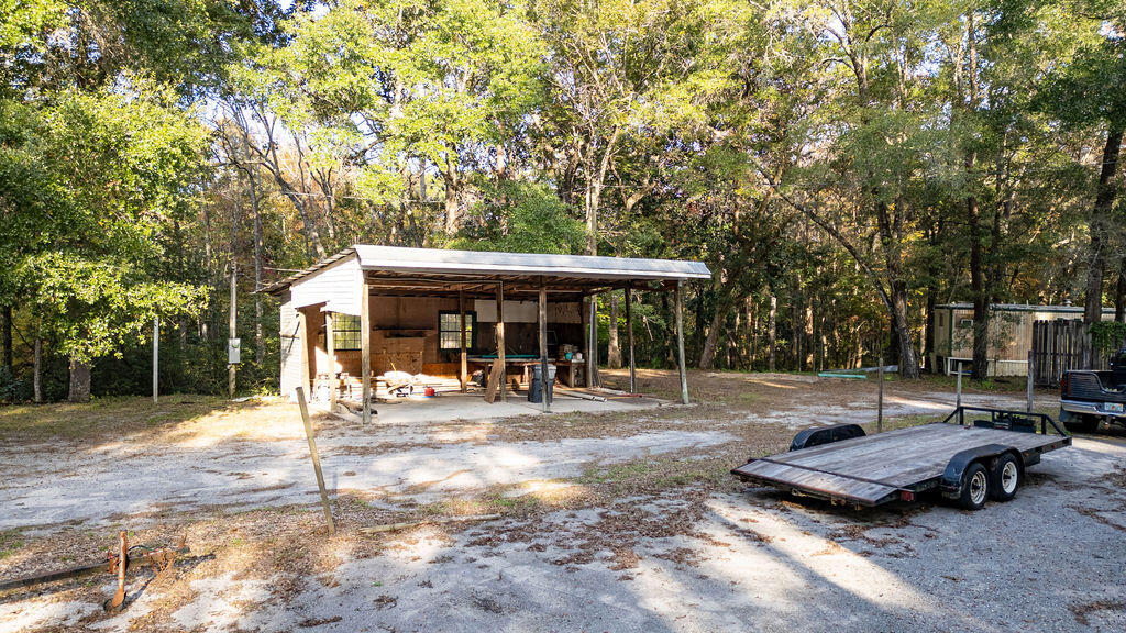 78 April Court Freeport, FL 32439 - Photo 15 of 18 a view of a backyard with table and chairs and a barbeque
