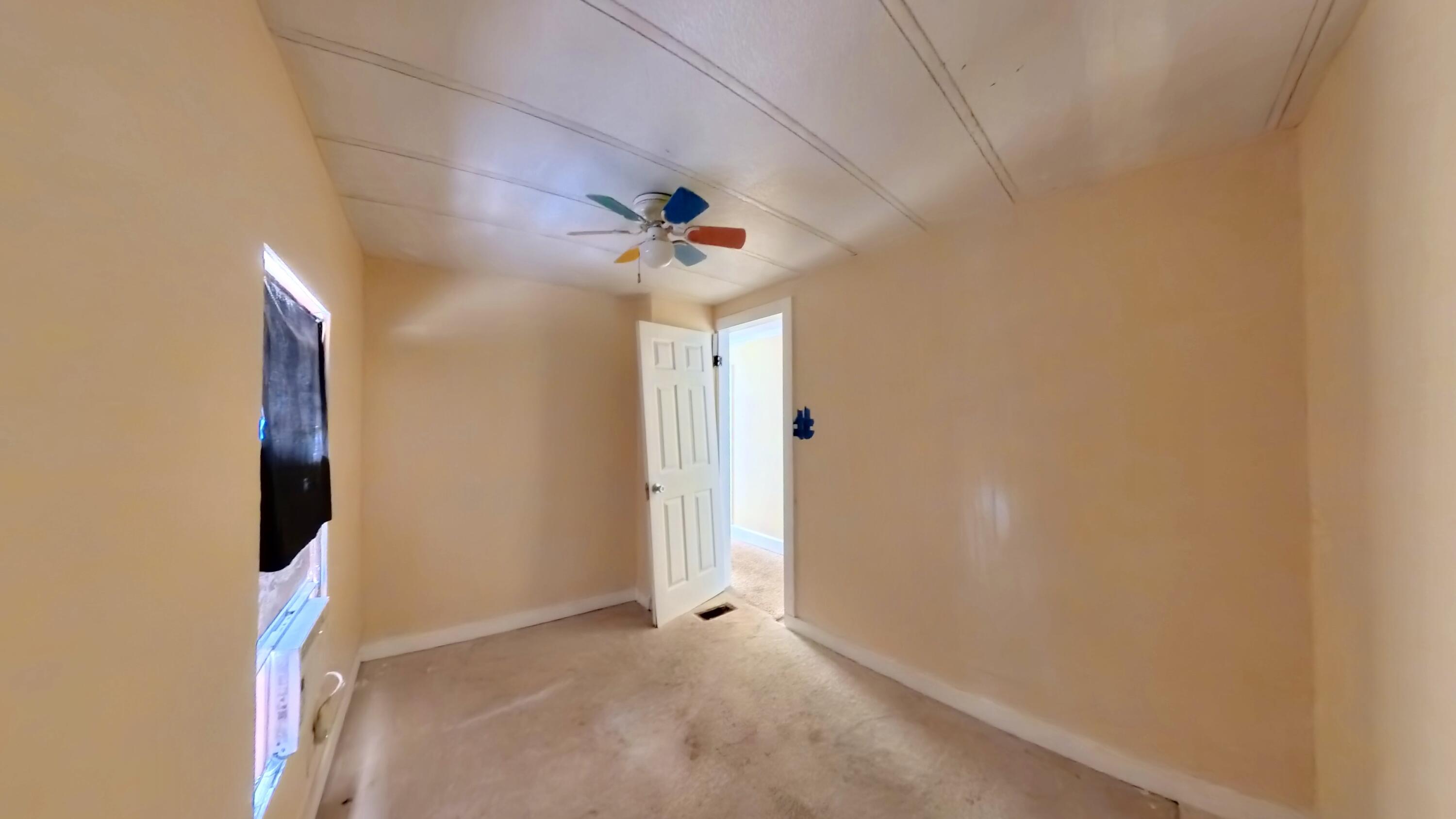 78 April Court Freeport, FL 32439 - Photo 28 of 39 an empty room with closet and a chandelier fan