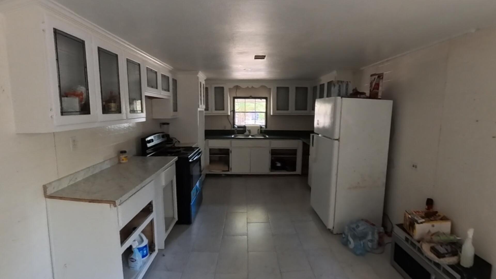 78 April Court Freeport, FL 32439 - Photo 29 of 39 a kitchen with a refrigerator and a sink