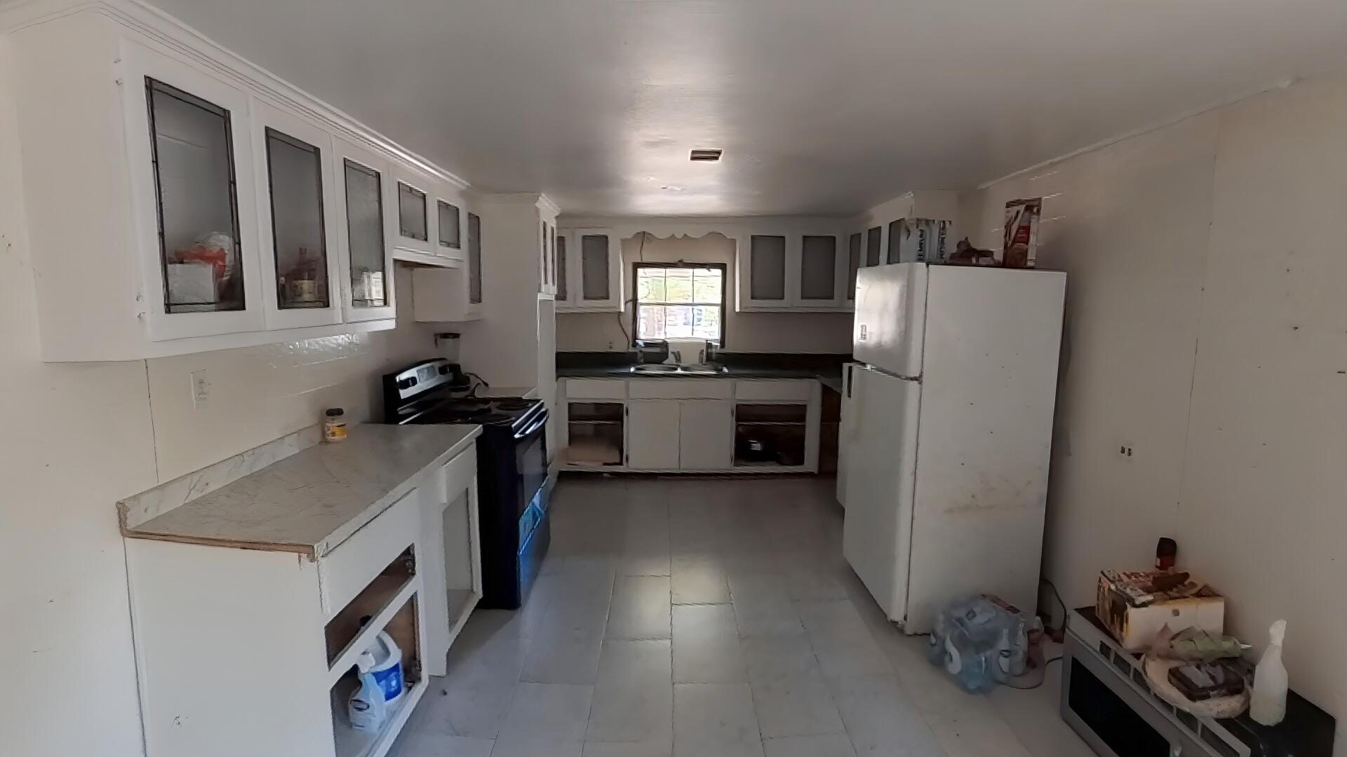 78 April Court Freeport, FL 32439 - Photo 30 of 39 a kitchen with a refrigerator and a sink