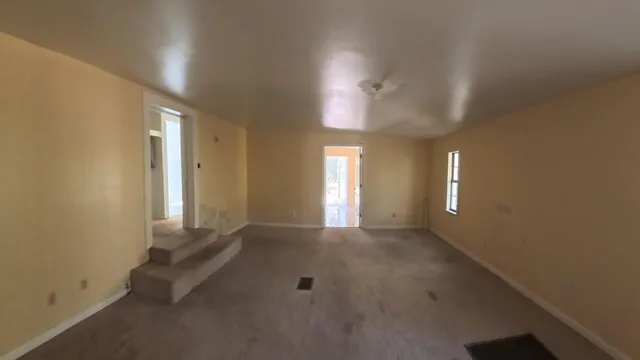 a patio with a table and chairs and a large tree