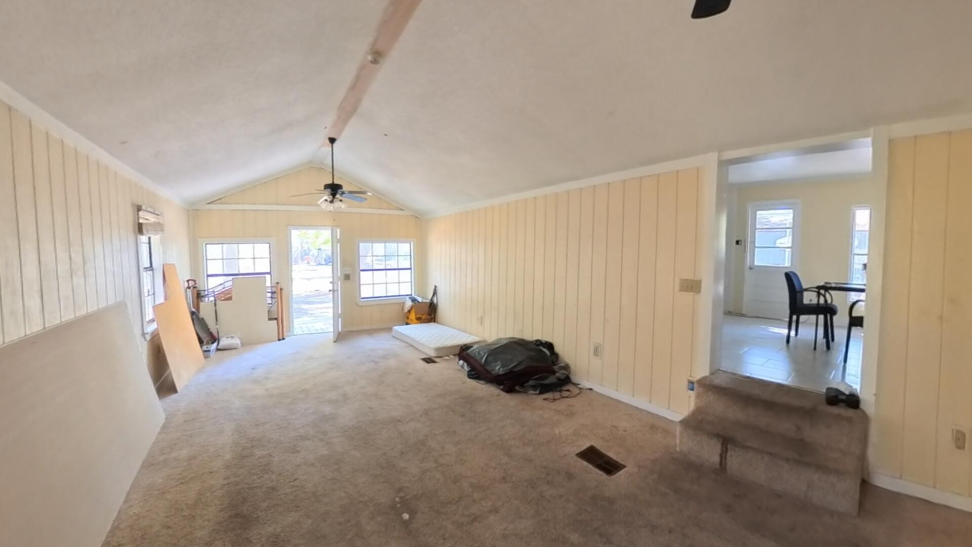 78 April Court Freeport, FL 32439 - Photo 34 of 39 a spacious bedroom with a bed and a chandelier