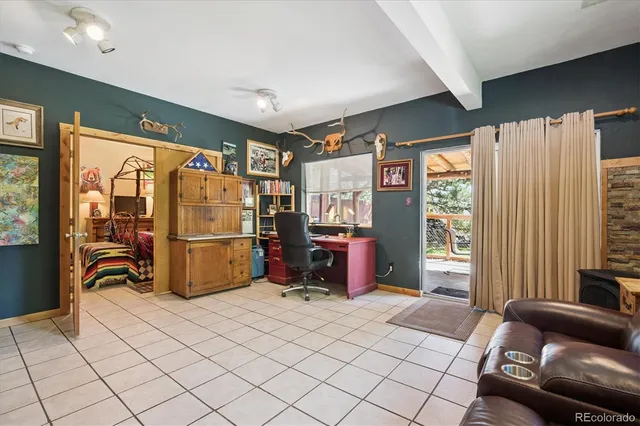 a bedroom with furniture and large windows