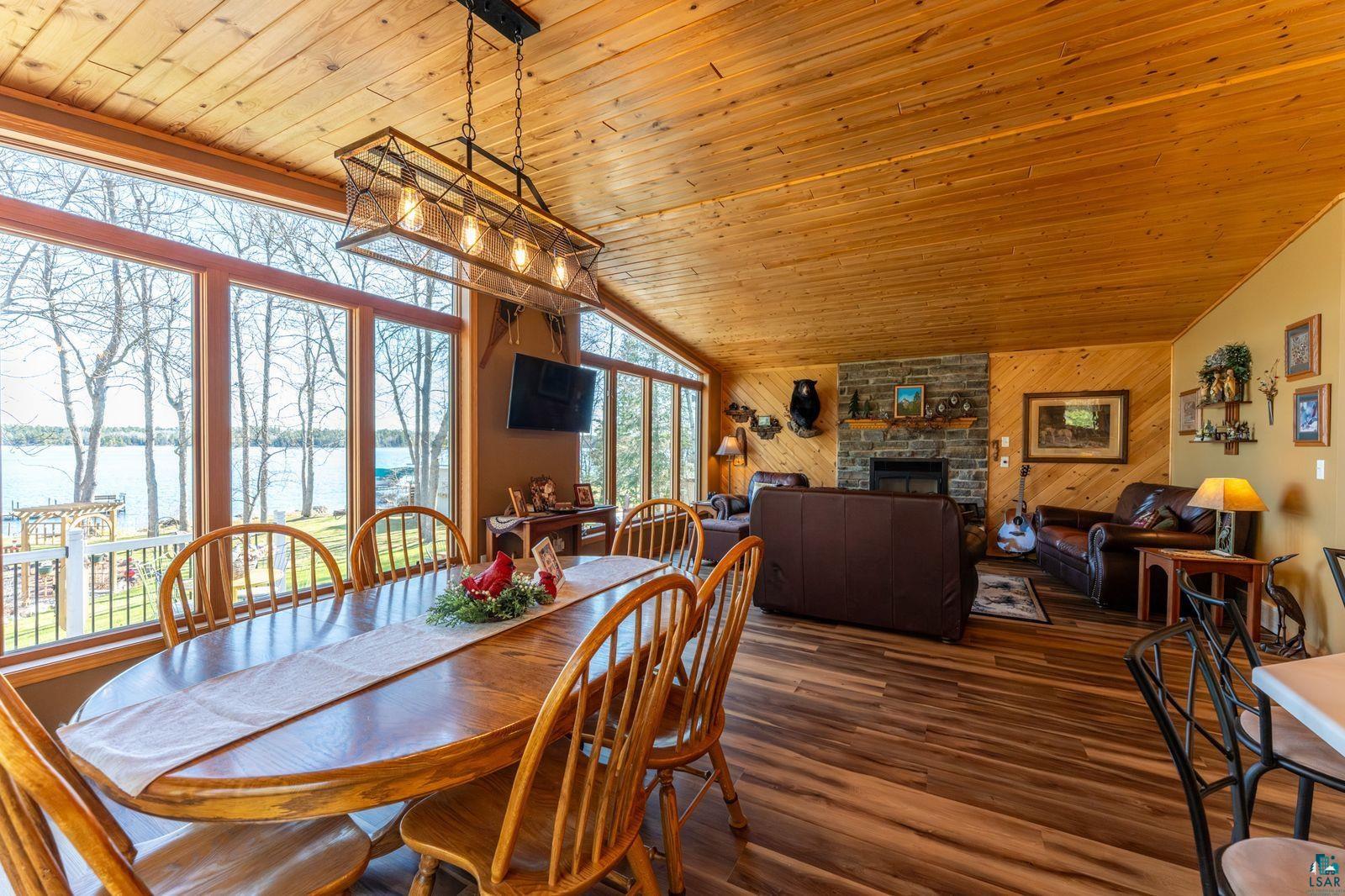 4452 Moccasin Point Road Tower, MN 55790 - Photo 9 of 44 Spacious open-concept room featuring wood-finish flooring and a wood-paneled ceiling