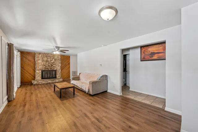 a living room with furniture and wooden floor