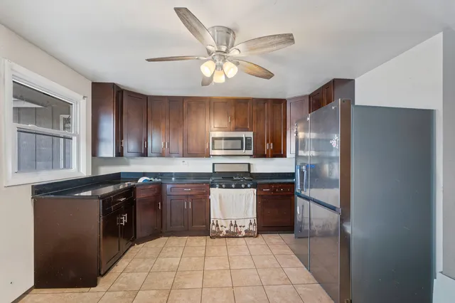a view of a hallway with chairs and a potted plant