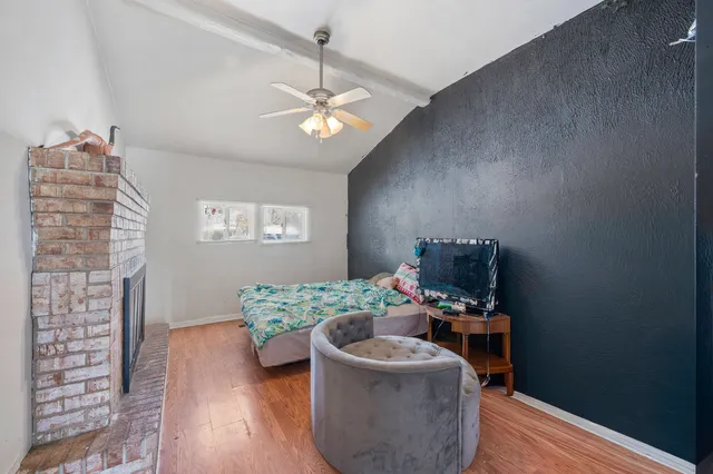 a bedroom with a bed and a fireplace