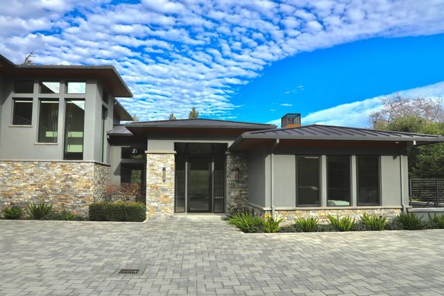 a living room with furniture a fireplace and a large window