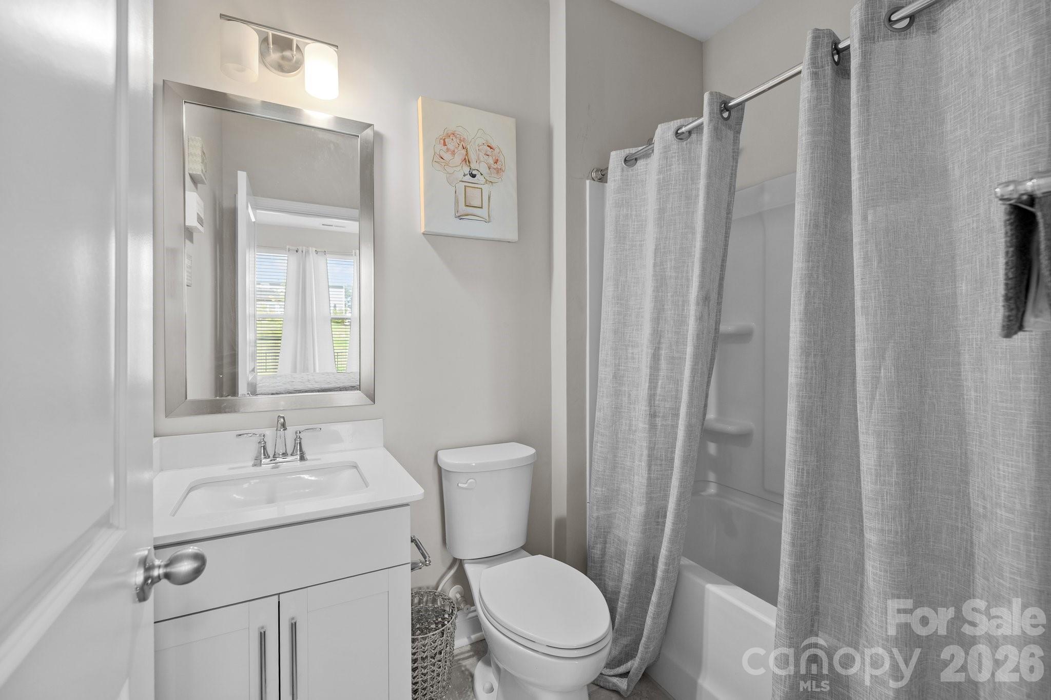 241 Boxelder Road Clover, SC 29710 - Photo 10 of 35 a bathroom with a sink a mirror a toilet and shower