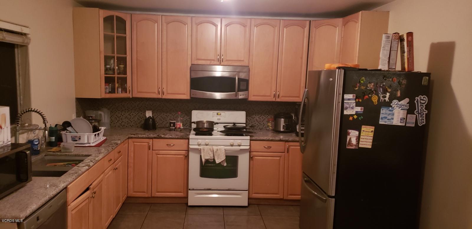 252 Smith Street Oxnard, CA 93033 - Photo 6 of 19 a kitchen with stainless steel appliances granite countertop a refrigerator a stove and a sink