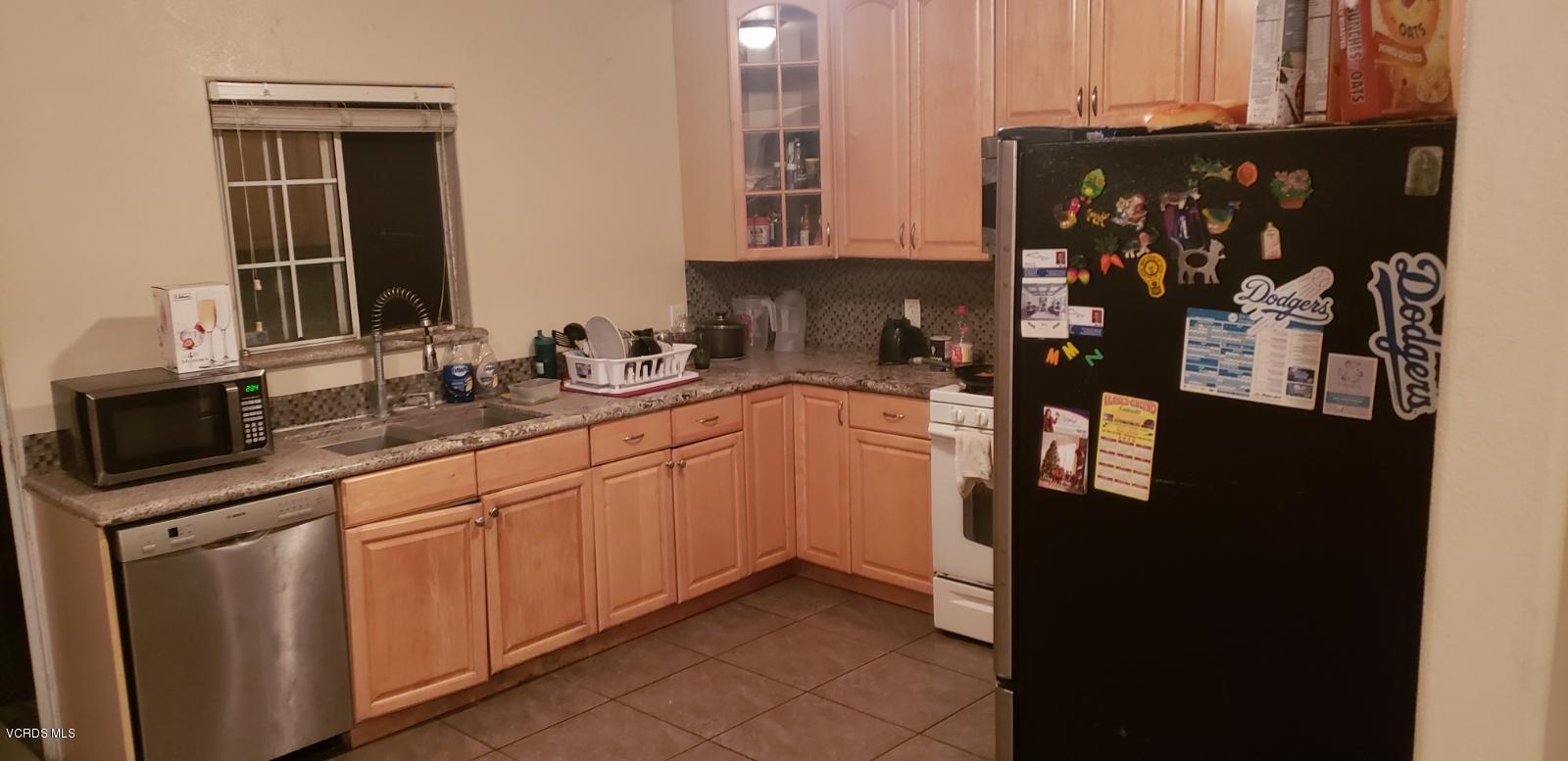 252 Smith Street Oxnard, CA 93033 - Photo 7 of 19 a kitchen with sink and cabinets