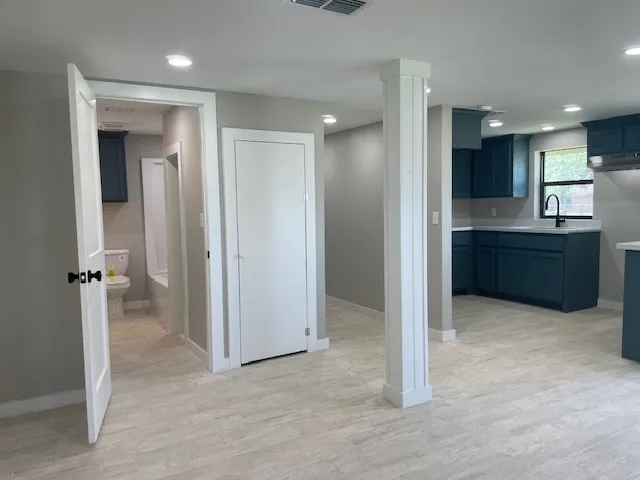 an empty room with a window and a fan