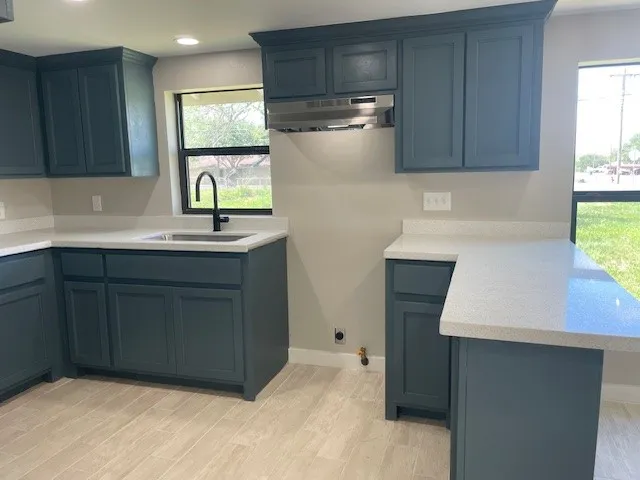 a kitchen with a sink cabinets and window