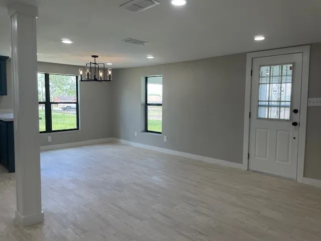 an empty room with windows and closet