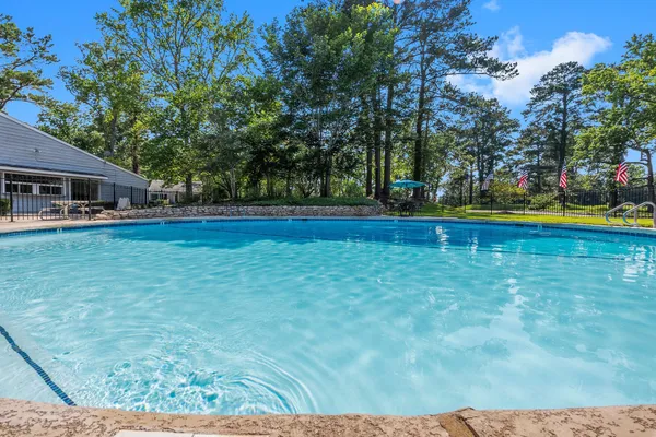 a view of pool and trees in the background